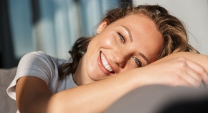 smiling young woman sitting on a sofa