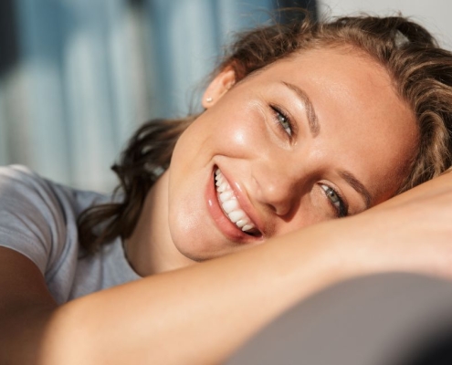 smiling young woman sitting on a sofa